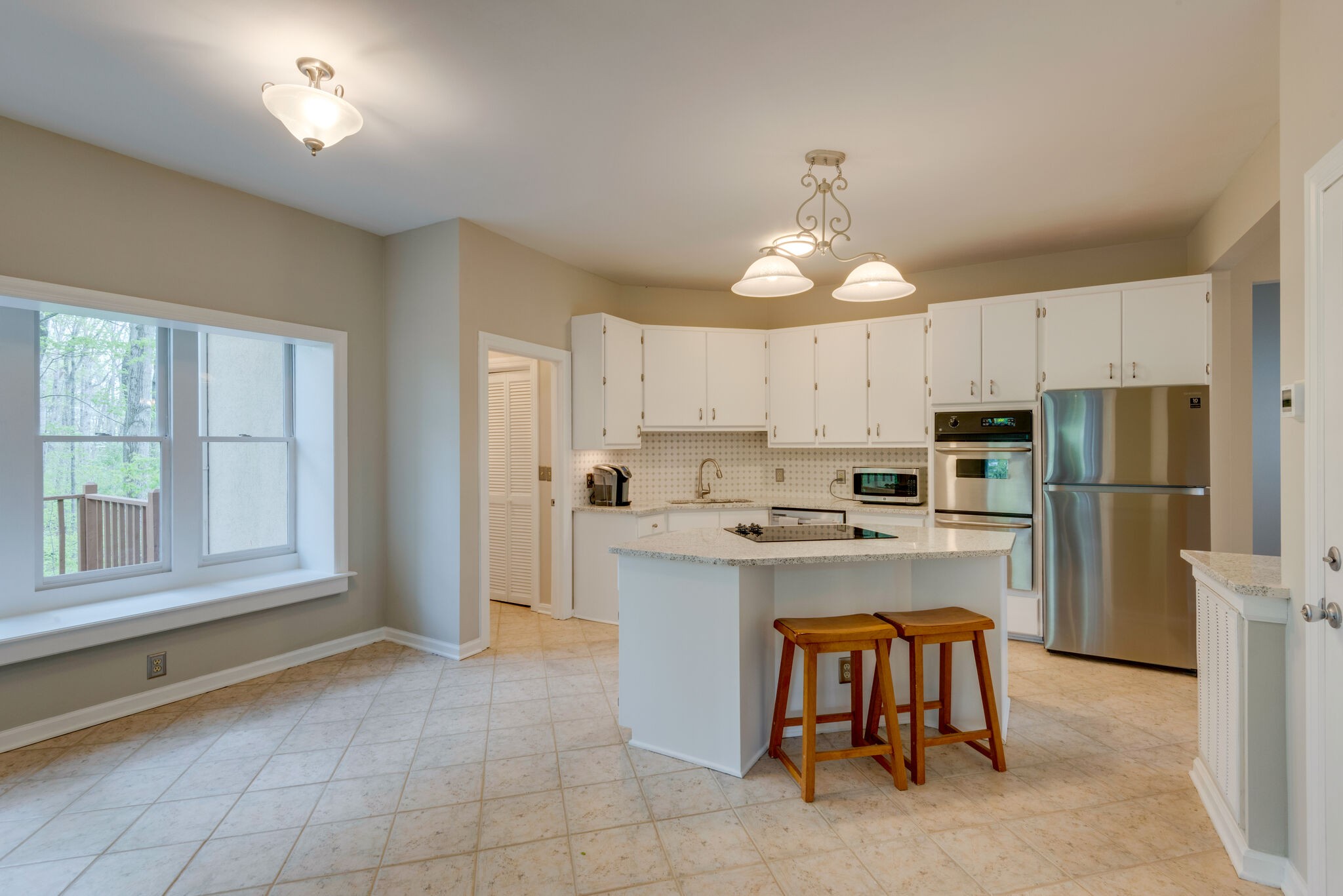 215 Brown Owl Road Fairview, TN 37062 - Photo 7 of 25 a kitchen with kitchen island granite countertop a stove oven and a refrigerator