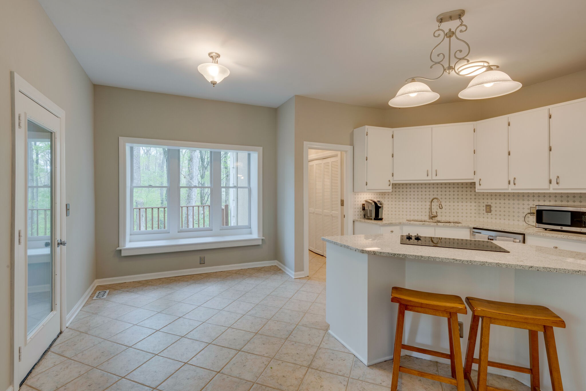 215 Brown Owl Road Fairview, TN 37062 - Photo 8 of 25 a kitchen with stainless steel appliances granite countertop a stove a sink a refrigerator and white cabinets with wooden floor