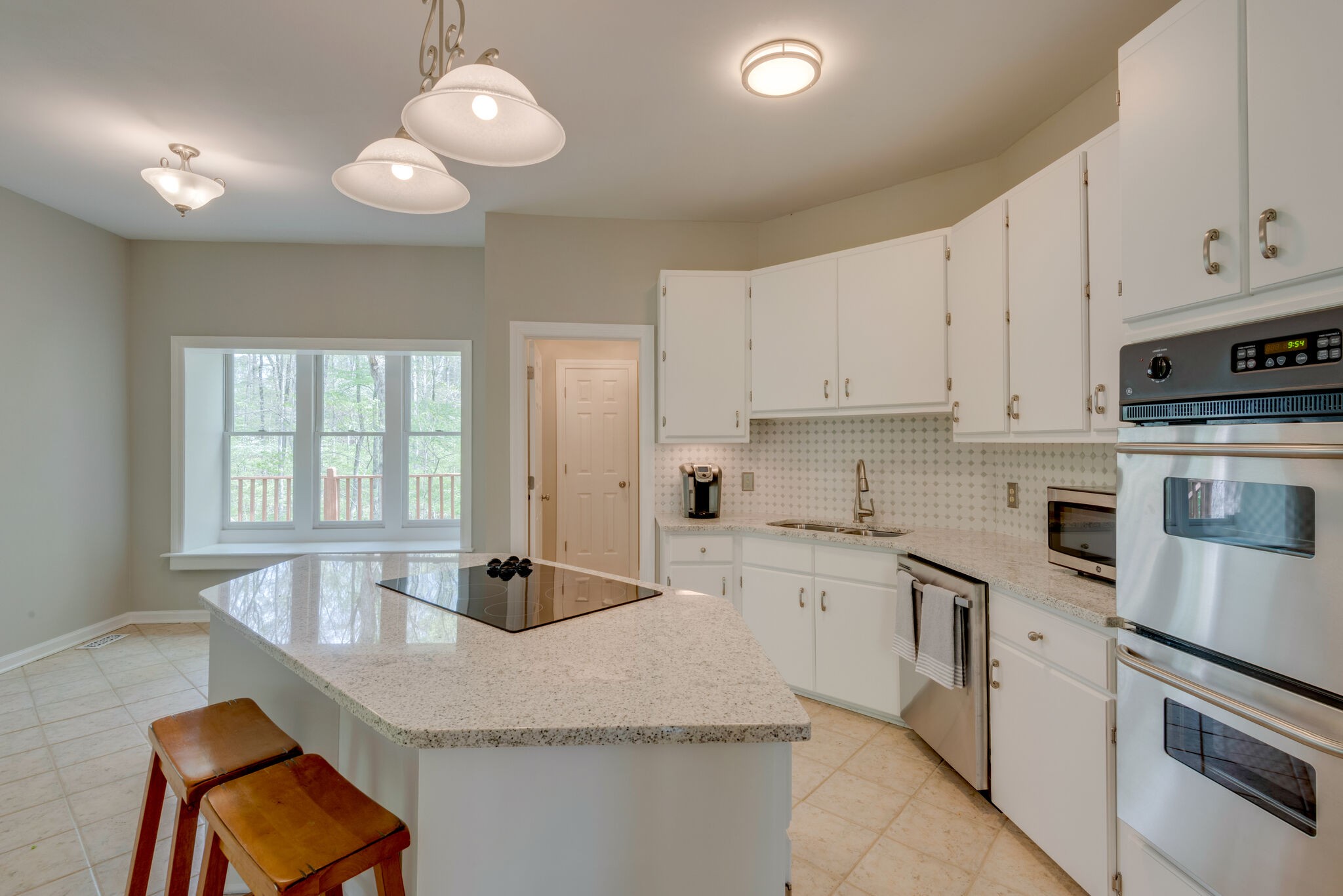 215 Brown Owl Road Fairview, TN 37062 - Photo 9 of 25 a kitchen with stainless steel appliances granite countertop a sink a stove and white cabinets
