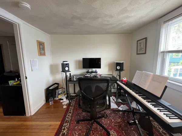 a view of a workspace with furniture and a window
