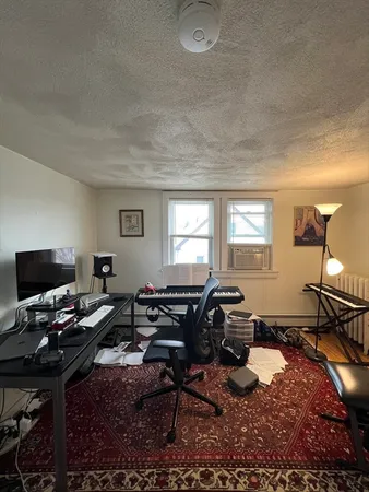 a living room with furniture a window and a flat screen tv