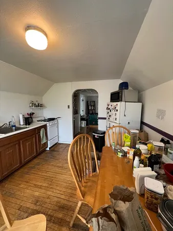 a living room with lots of furniture and kitchen view