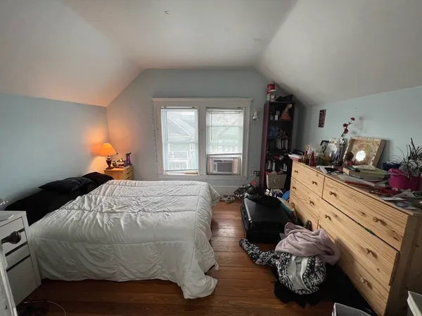 a bed room with a bed and a window