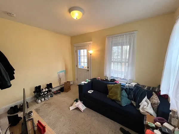 a living room with furniture window and gym equipment