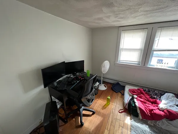 a bedroom with a bed and a window