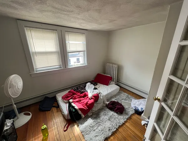 a living room with furniture rug and a window