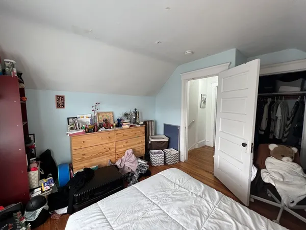 a bedroom with a bed and a closet