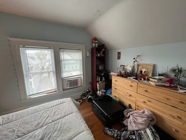 a bed room with a bed and a window