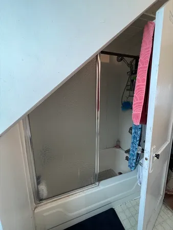 a bathroom with a bathtub and a shower