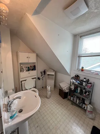 a bathroom with a sink mirror and window
