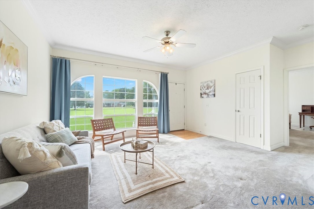 a living room with furniture and a large window