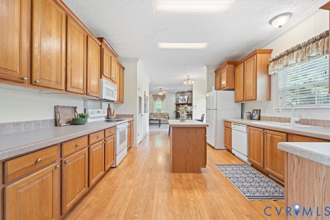 28231 Lewis Moore Road Ruther Glen, VA 22546 - Photo 11 of 50 a large kitchen with stainless steel appliances granite countertop a lot of counter space and wooden floors