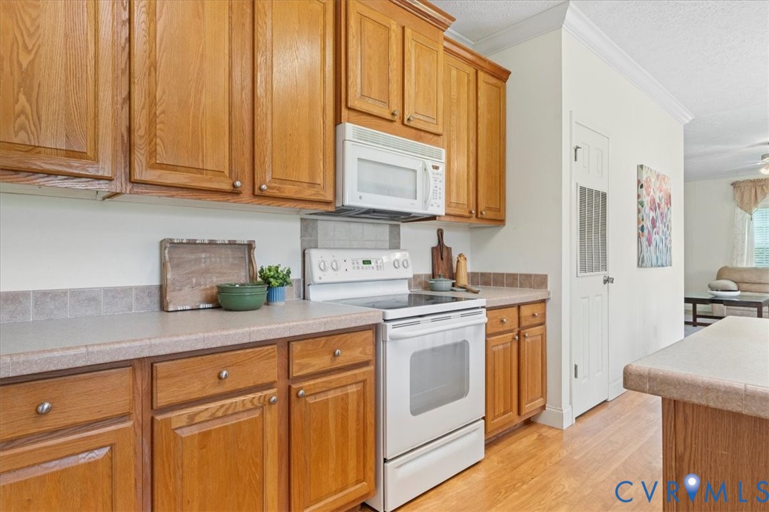 28231 Lewis Moore Road Ruther Glen, VA 22546 - Photo 13 of 50 a kitchen with stainless steel appliances granite countertop a sink a stove and cabinets