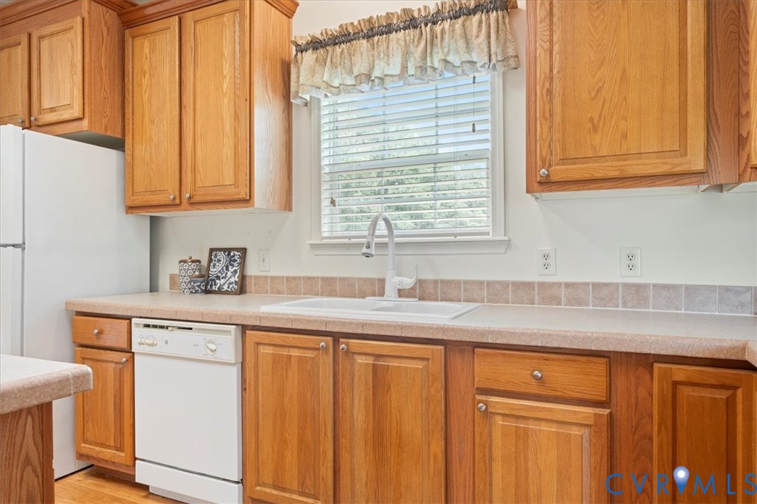 28231 Lewis Moore Road Ruther Glen, VA 22546 - Photo 14 of 50 a kitchen with stainless steel appliances granite countertop a sink and cabinets with wooden floor