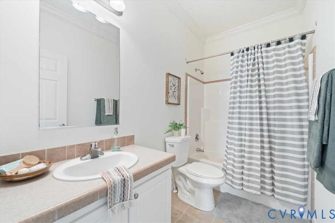28231 Lewis Moore Road Ruther Glen, VA 22546 - Photo 26 of 50 a bathroom with a granite countertop sink toilet and shower