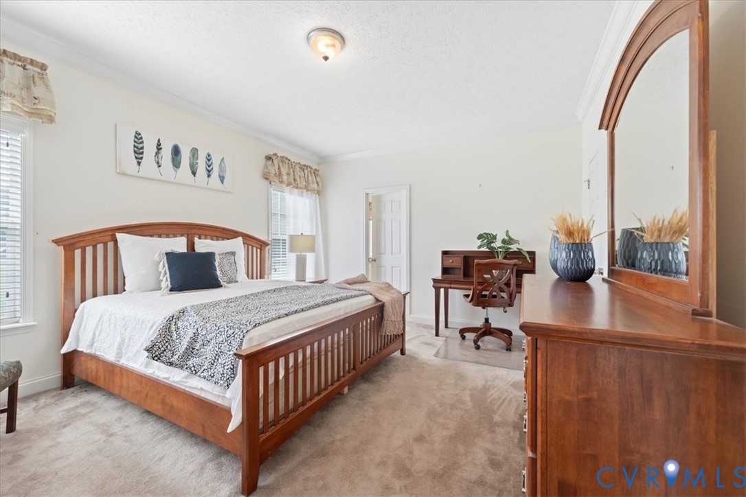 28231 Lewis Moore Road Ruther Glen, VA 22546 - Photo 30 of 50 a bedroom with a bed and large windows