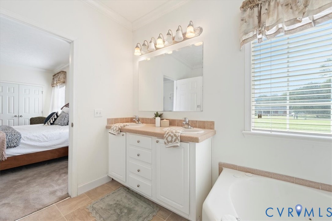 28231 Lewis Moore Road Ruther Glen, VA 22546 - Photo 34 of 50 a en suite bathroom with a double vanity sink and a mirror