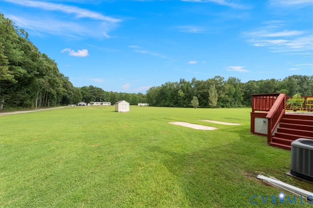 28231 Lewis Moore Road Ruther Glen, VA 22546 - Photo 37 of 50 a backyard of a house with lots of green space