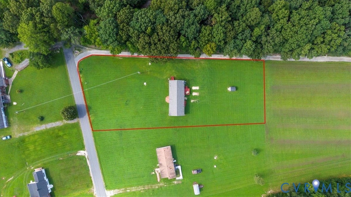 28231 Lewis Moore Road Ruther Glen, VA 22546 - Photo 47 of 50 a green field with trees in the background