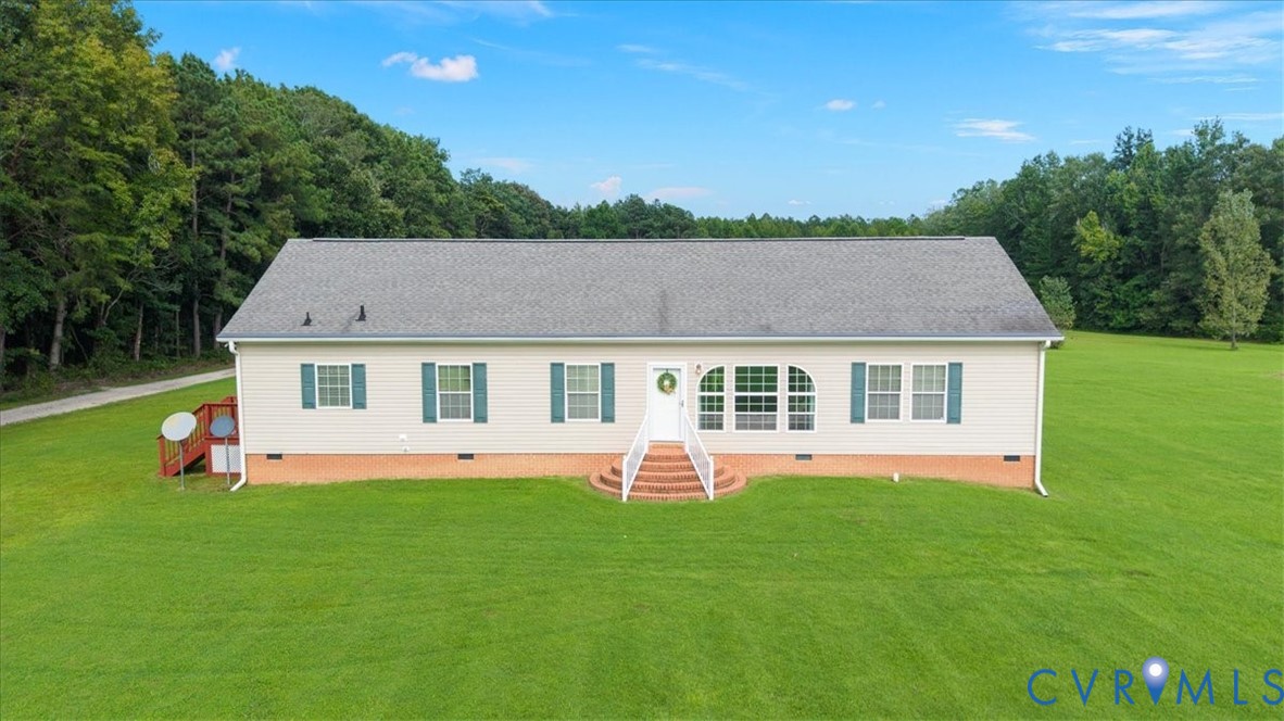 28231 Lewis Moore Road Ruther Glen, VA 22546 - Photo 7 of 50 a front view of house with yard and trees in the background