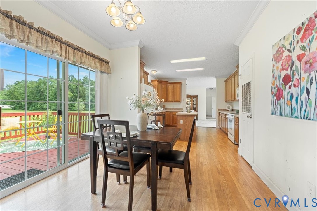 28231 Lewis Moore Road Ruther Glen, VA 22546 - Photo 10 of 50 a view of a dining room with furniture a chandelier and wooden floor