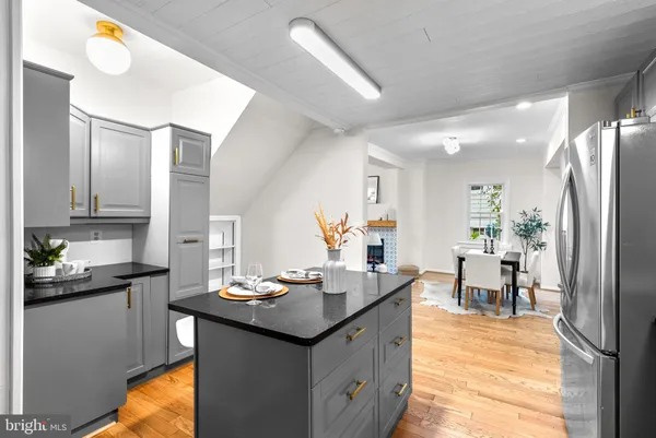 a kitchen with granite countertop a sink and cabinets
