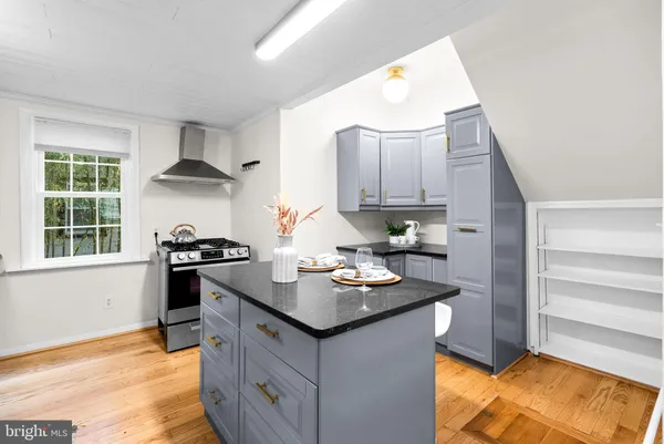 a kitchen that has a sink and a stove in it