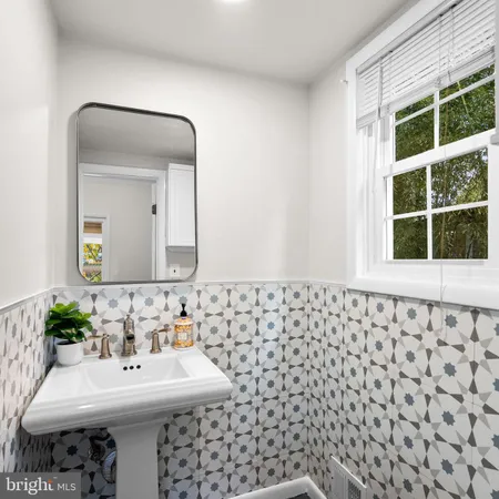 a bathroom with a sink a mirror and a shower