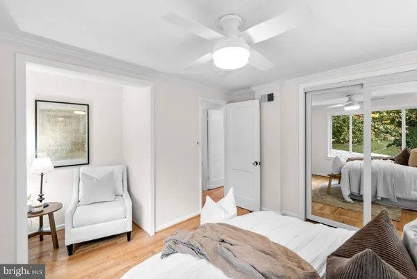 a bedroom with furniture and a large mirror