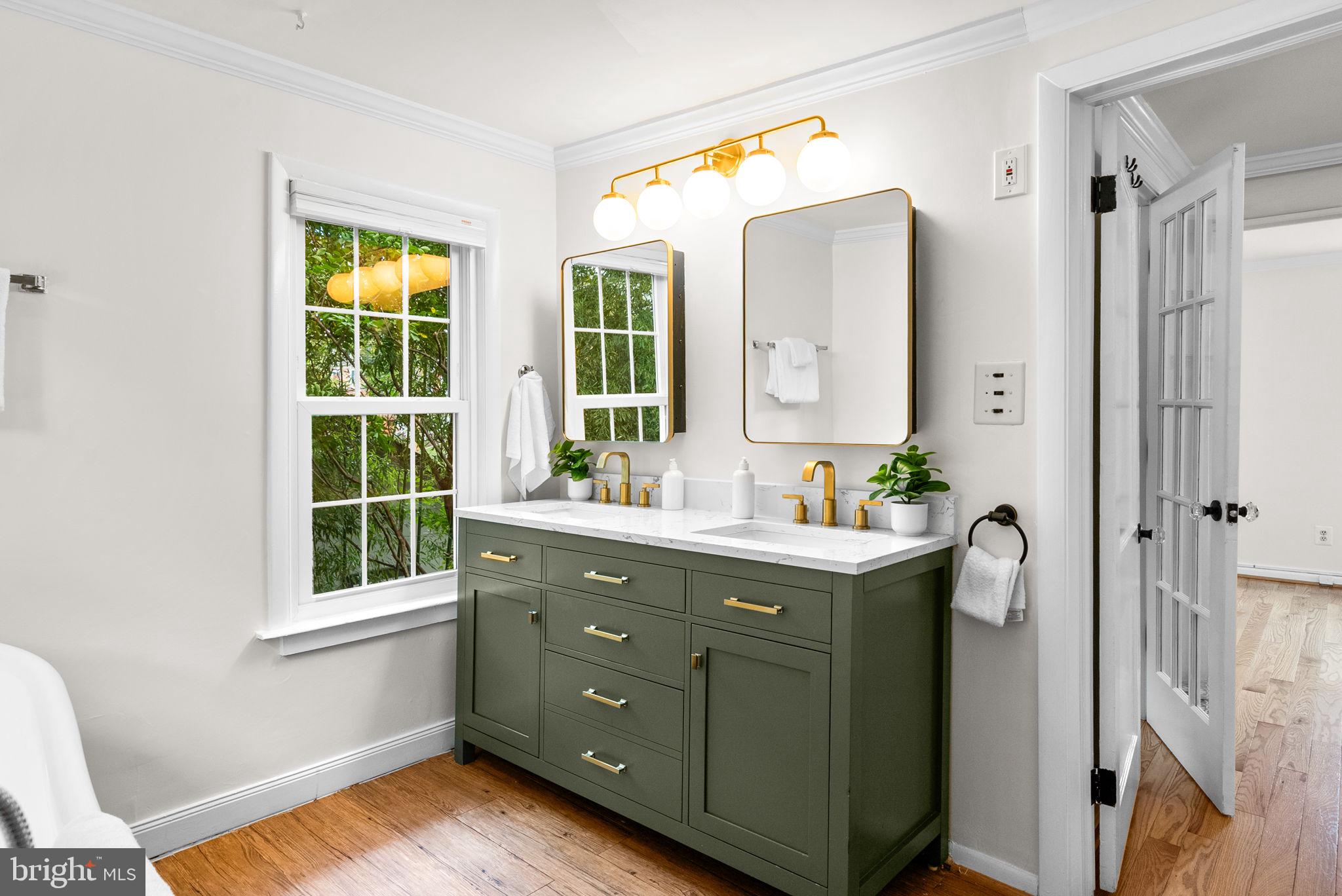 725 Silver Spring Avenue Silver Spring, MD 20910 - Photo 19 of 41 a bathroom with a double vanity sink and mirror with bathtub