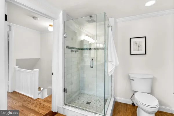 a bathroom with a shower a toilet and a sink