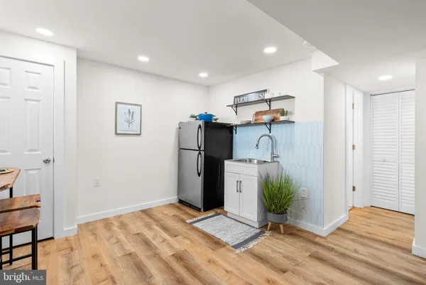 a view of a kitchen with a sink and refrigerator