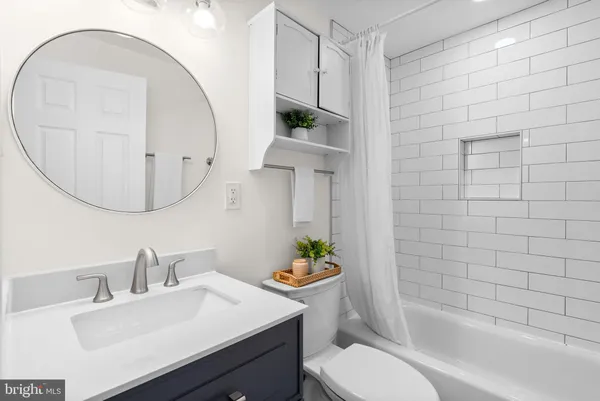 a bathroom with a sink a toilet and tub