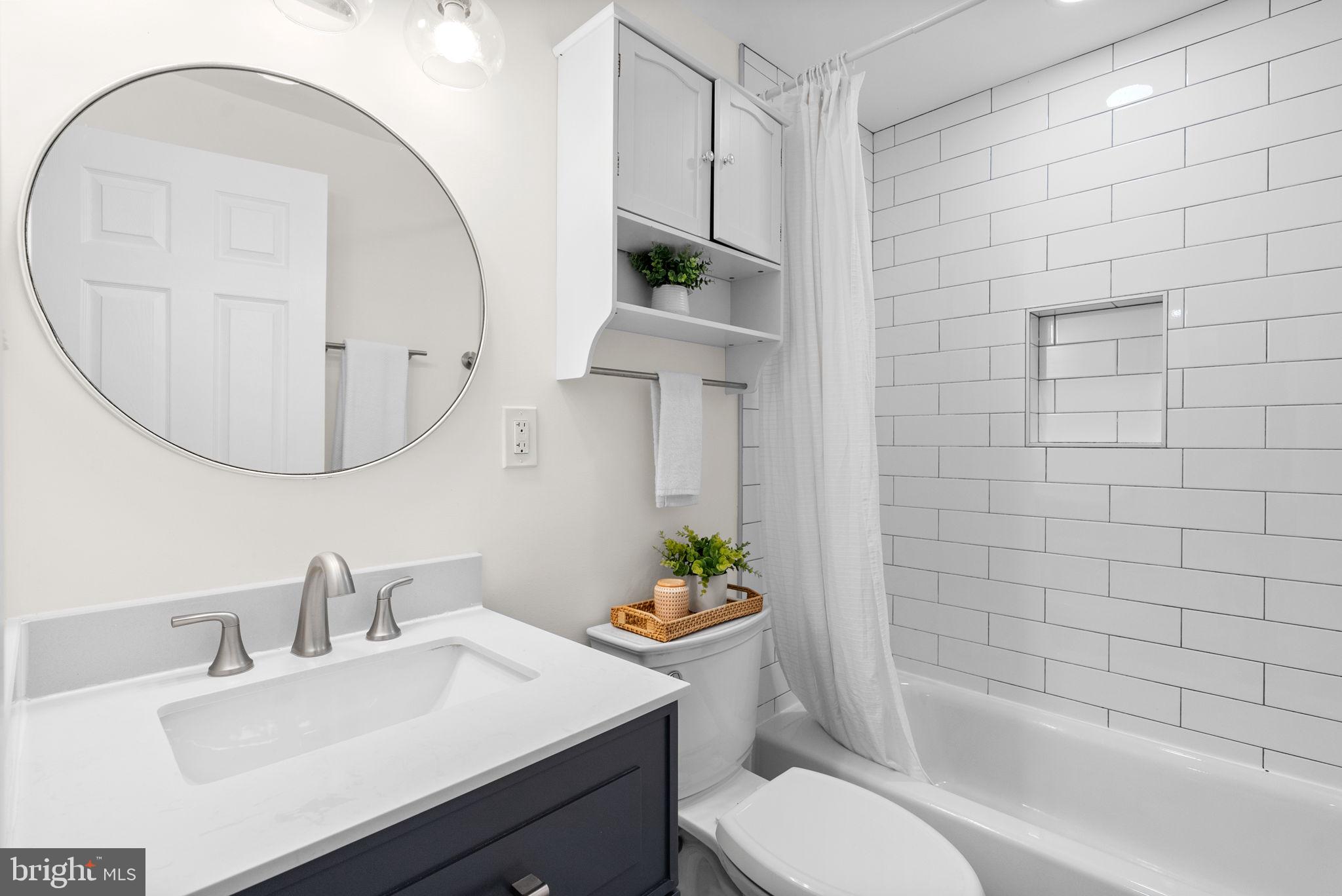 725 Silver Spring Avenue Silver Spring, MD 20910 - Photo 28 of 41 a bathroom with a sink a toilet and tub