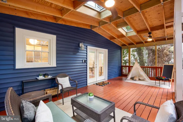 a outdoor space with the couches and dining table with the wooden floor