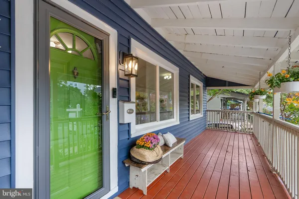 a porch with seating space and hardwood floor
