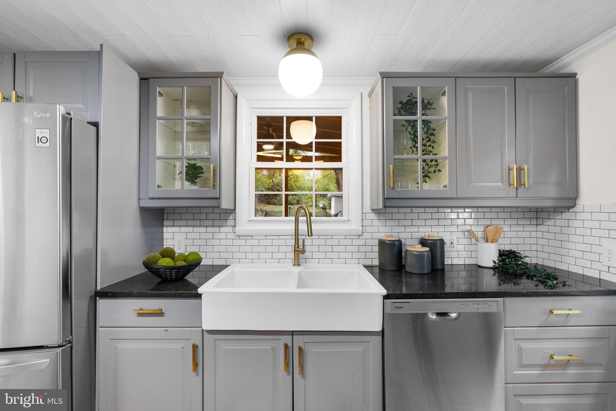 725 Silver Spring Avenue Silver Spring, MD 20910 - Photo 9 of 41 a kitchen with stainless steel appliances a sink a refrigerator and a window