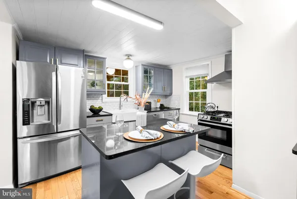 a kitchen with a sink stainless steel appliances and cabinets