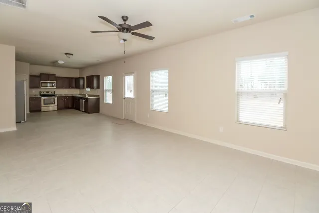 a view of a livingroom with furniture and a ceiling fan