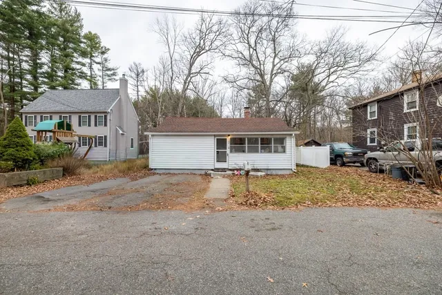 a view of a house with a yard covered in snow