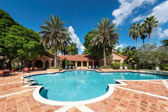 a view of a house with swimming pool and sitting area