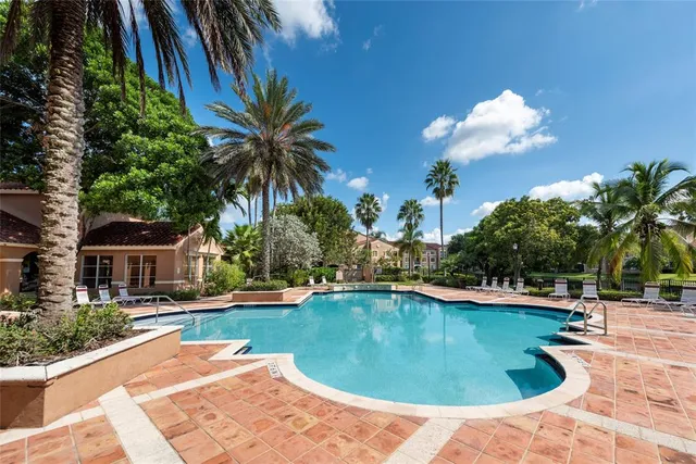 a swimming pool with outdoor seating and yard