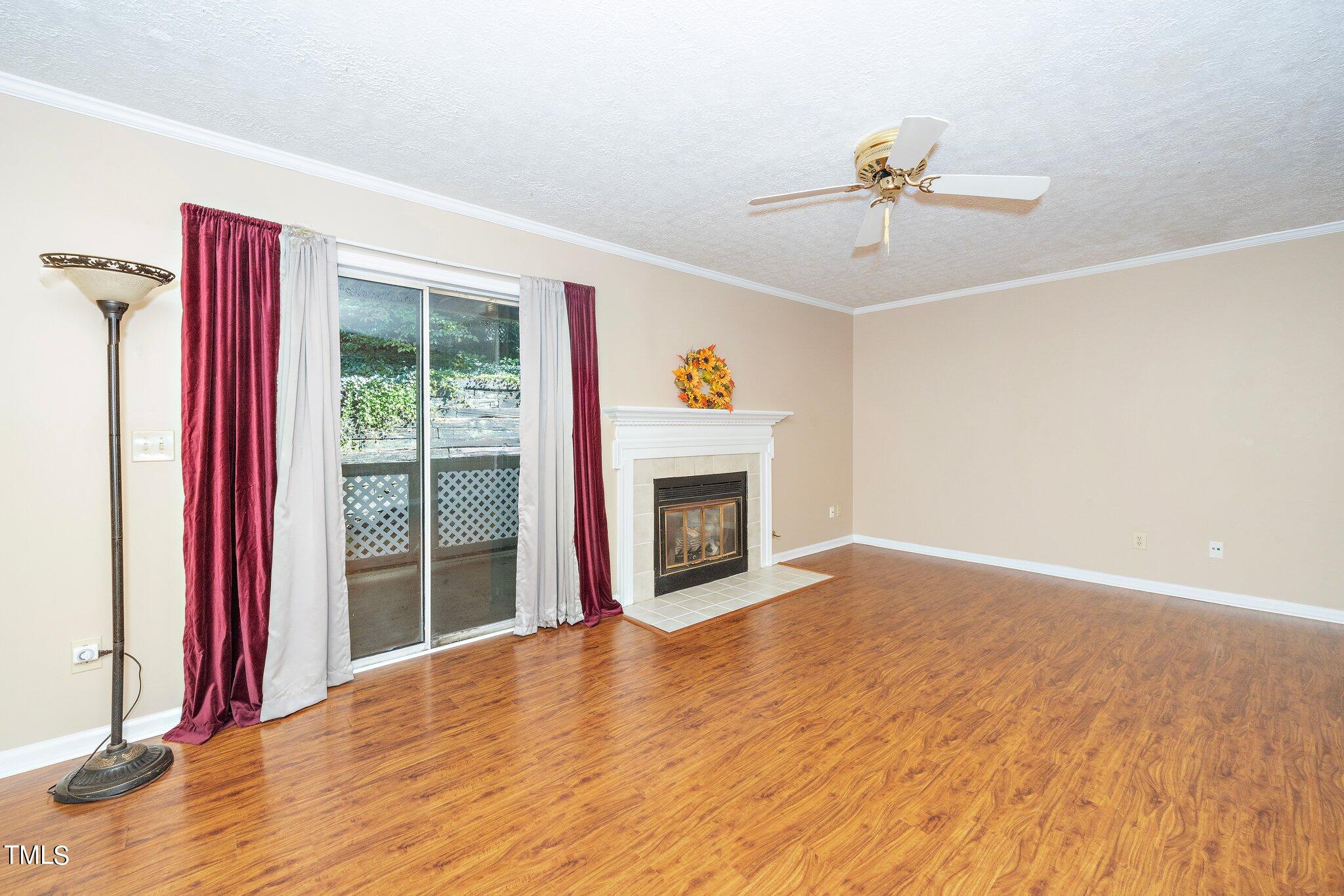 604 Broad Leaf Circle Raleigh, NC 27613 - Photo 12 of 23 a view of a livingroom with a fireplace wooden floor and window