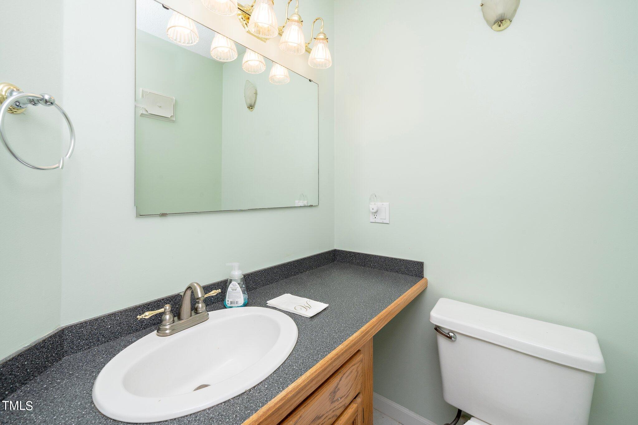 604 Broad Leaf Circle Raleigh, NC 27613 - Photo 7 of 23 a bathroom with a sink a toilet and mirror