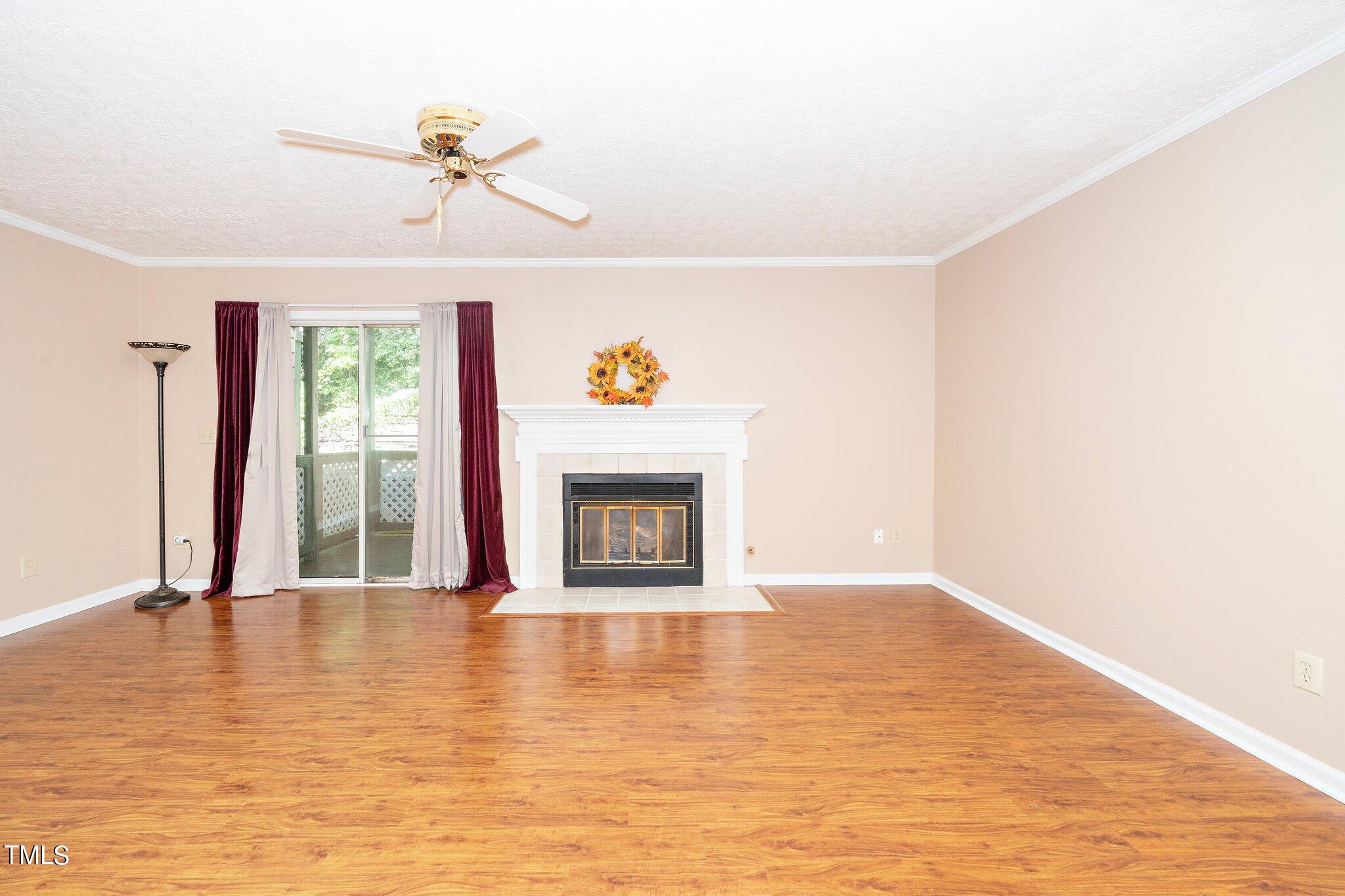 604 Broad Leaf Circle Raleigh, NC 27613 - Photo 10 of 23 a view of an empty room with window and wooden floor