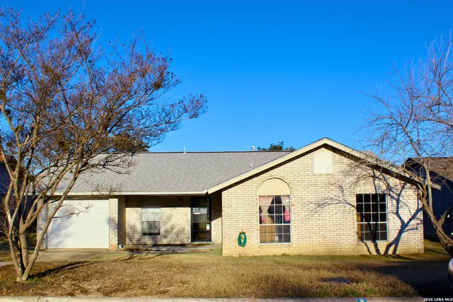 a view of a white house with a yard
