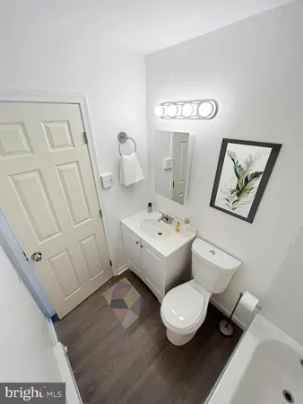 a bathroom with a toilet a sink and mirror