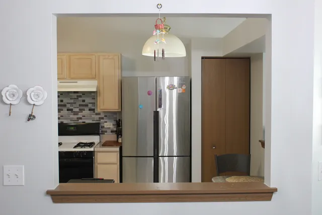 a view of a kitchen from the hallway