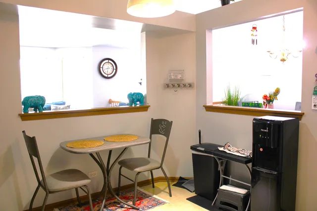 a view of a dining room with furniture and a window