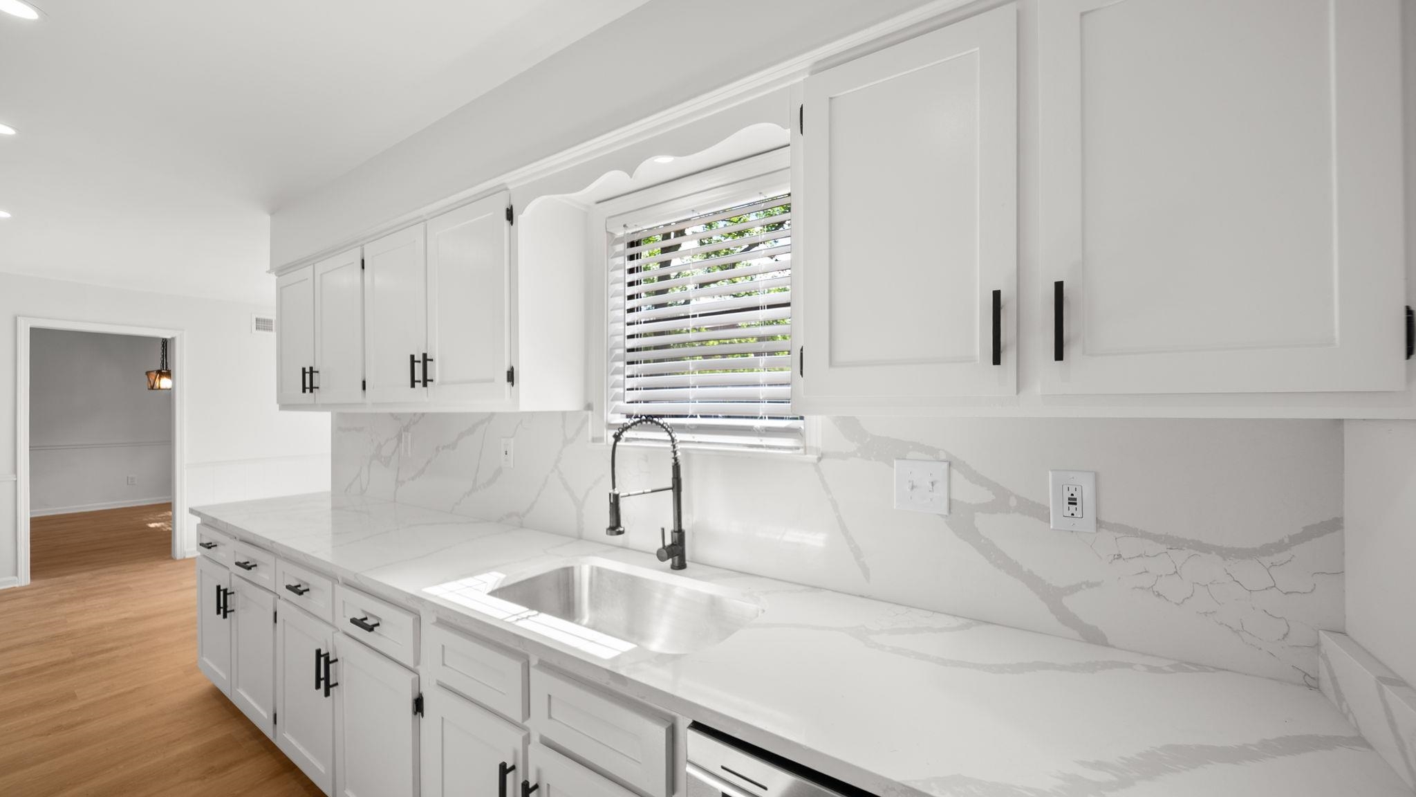 4351 Spring Oak Cove Memphis, TN 38125 - Photo 19 of 40 a kitchen with white cabinets and a sink